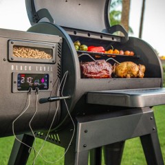 Black Label Series Pellet Grill from Louisiana Grill with Wi-Fi control in a garden – We Love Fire