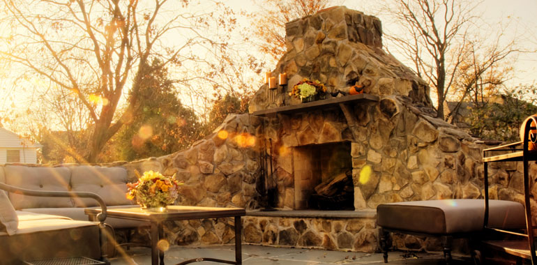 Outdoor patio living area with a fireplace