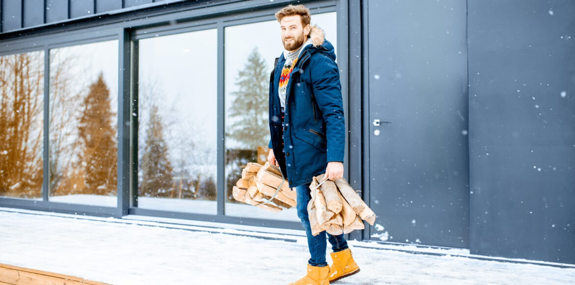 To Do List Before Lighting Your First Fire Of The Season - a man with his wood for the fireplace