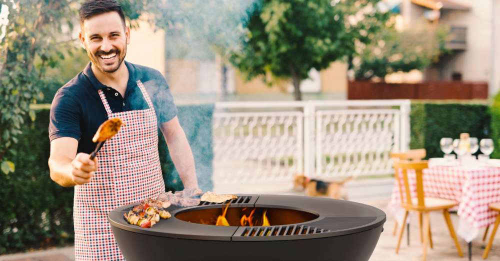 Man with apron cooking on a BBQ, Grill. How to host the best social distancing summer BBQ ever!