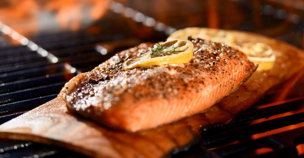 Salmon on cedar plank with herbs and lemon. Low n slow smoked salmon.