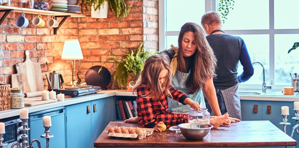 Kitchen Ambiance to Create a Haven for You and Your Guests - a family is cooking in their kitchen