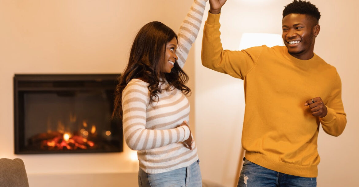 The Romance of Winter_ Date Night Ideas by the Fireplace - a couple is dancing by the fireplace