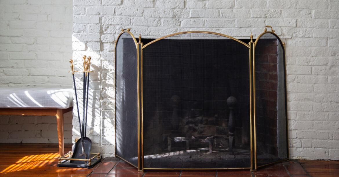 A fireplace with a fire screen for fireplace safety