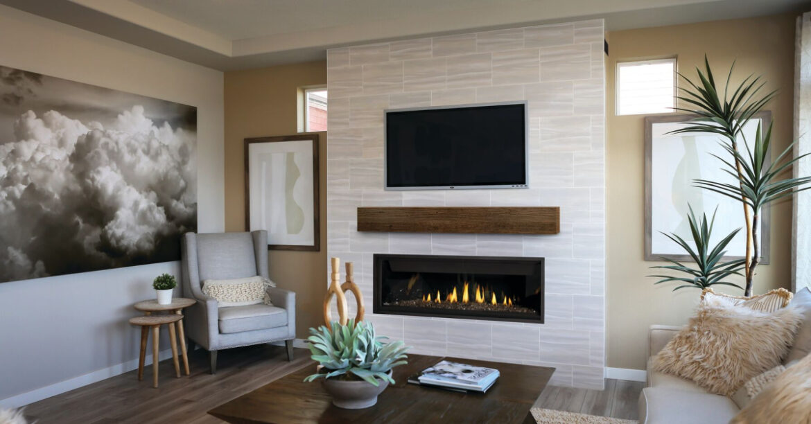 A beautiful living room with a gas fireplace with a tv above it and a mantle