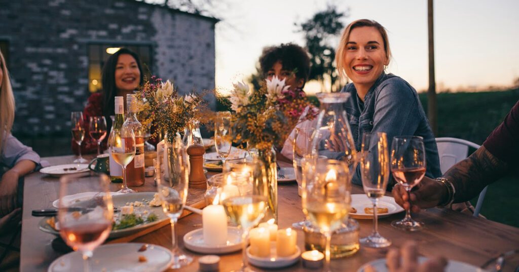 Friends are enjoying a cozy alfreso dinner outside at night